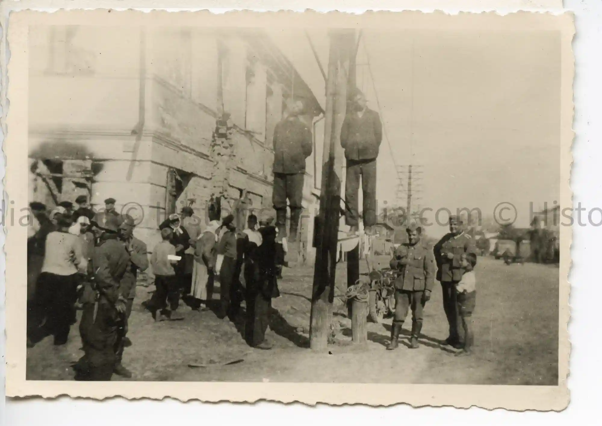 TWO HANGED RUSSIAN PARTISANS W/ GERMAN SOLDIERS POSING NEARBY TWO HANGED RUSSIAN PARTISANS W/ GERMAN SOLDIERS POSING NEARBY