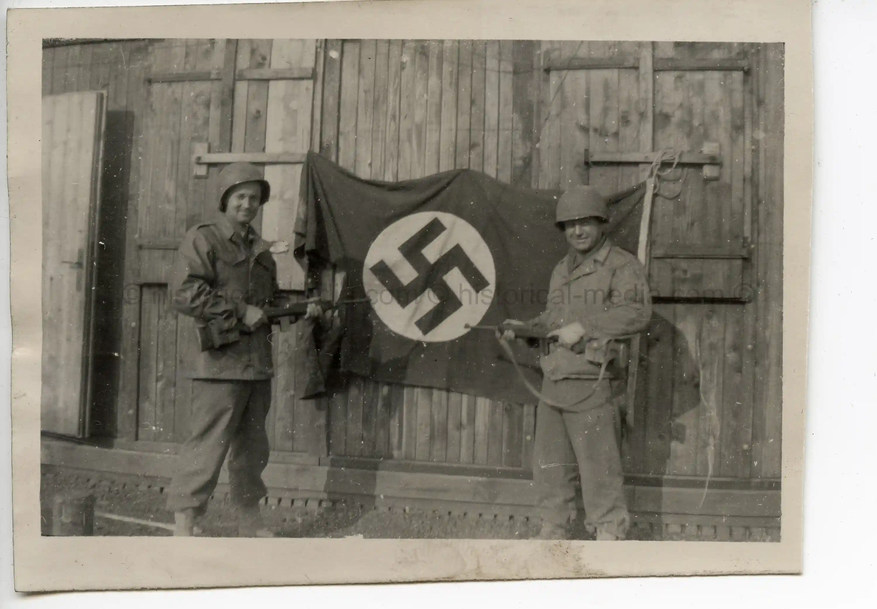 USGI PHOTOS - SOLDIERS POSE W/ CAPTURED GERMAN FLAG - FEB. 1945