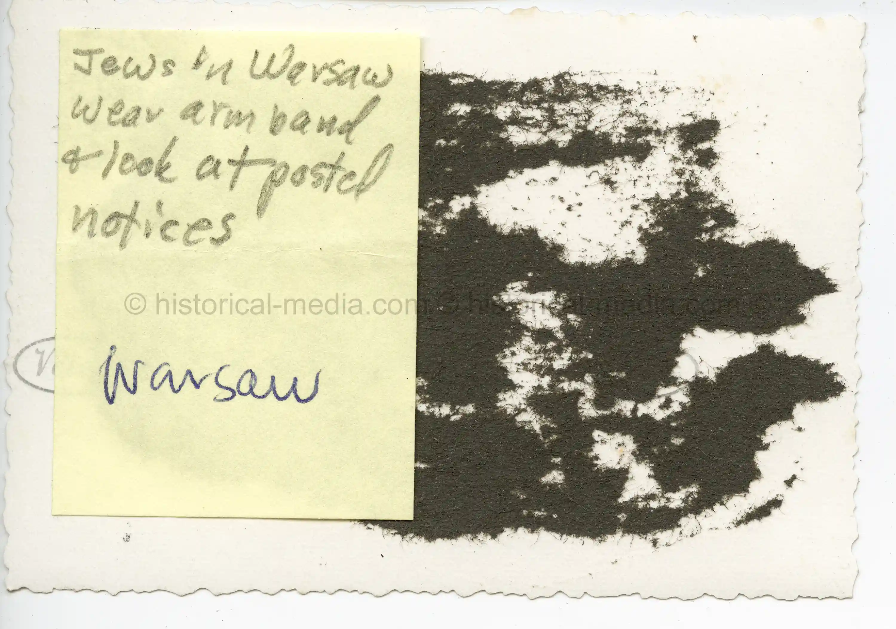 GERMAN PHOTO OF JEWS IN WARSAW WEARING ARMBANDS READING POSTED NOTICES